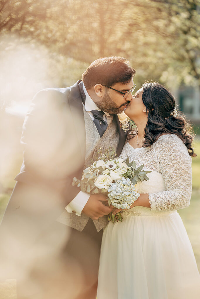 Indian wedding couple kissing at their wedding 